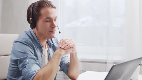Workplace of freelance worker at home office. Young man works using computer.