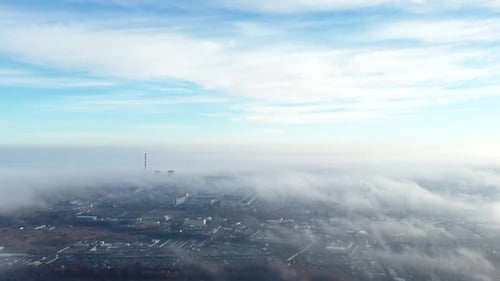 Aerial Drone View Flight Over Above Fog Mist and Roofs of Buildings in City