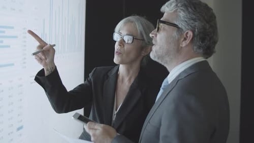 Business People Analyzing Data in a Modern Office