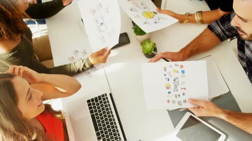 Team of executives interacting with each other while working in the office