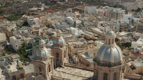 Nice Looking Blue and Beige Church in Small Mediterranean Town on Malta Island, Aerial Tilt Down in