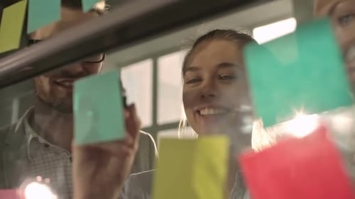 Team Brainstorming with Sticky Notes in Office