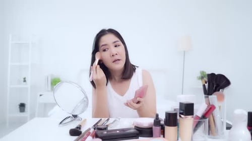 Joven asiática usa cosmética reseña tutorial de maquillaje retransmite vídeo en directo a la red social.