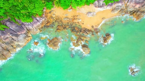 Aerial Top views over beaches, ocean waves crashing on rocks and sand