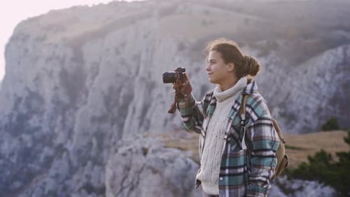 Woman Takes Photo On Mountain Peak