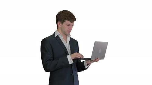 Smiling Young Adult in Suit Working on Laptop