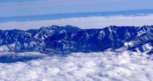 Snow Capped Mountains Above a Cloud Layer