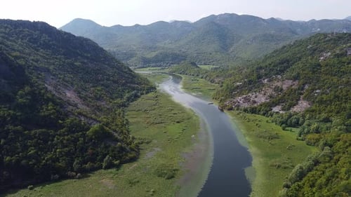 River Flowing Along the Valley Between Two Mountain Ranges