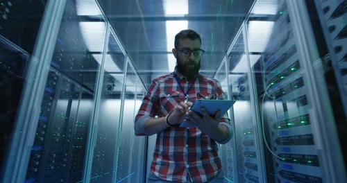 Man Working on Tablet in Data Server Room