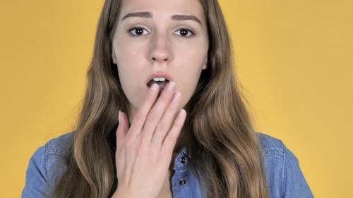 Close Up of Pretty Woman in Shock Isolated on Yellow Background Wondering