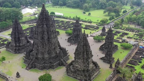 Hindu temple Prambanan in Yogyakarta, Indonesia during humid conditions, Aerial pedestal rising shot