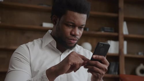 Portrait of an Adult Man Browsing on His Smartphone