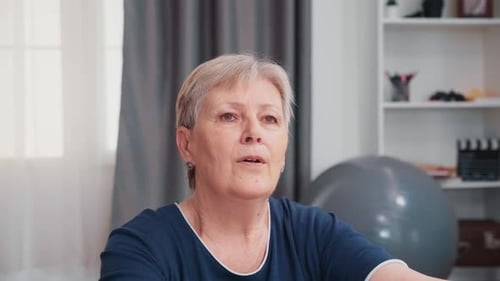 Senior Woman Practicing Breathing Exercises at Home