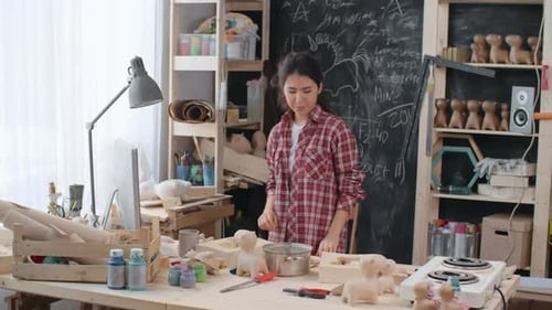 Woman Prepares to Work in Her Art Studio