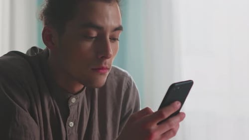 Young Man Read Message In Mobile Phone