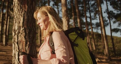 Active senior woman hiking in forest