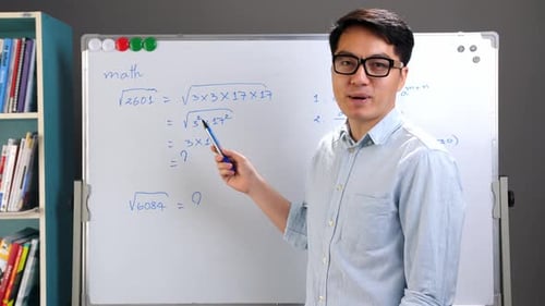 Young Adult Teaching Math Equations on Whiteboard