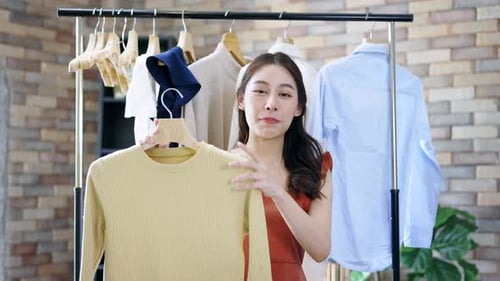 Young Woman Presenting Fashion Clothes in Studio