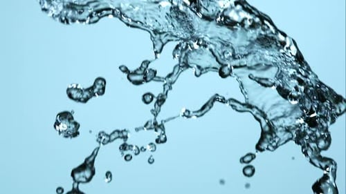 Abstract Water Stream Splashing Against Light Blue Background