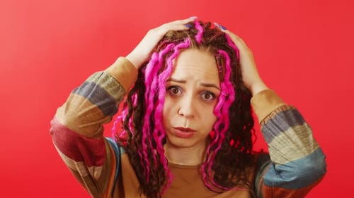 Worried Woman with Hands on Her Head