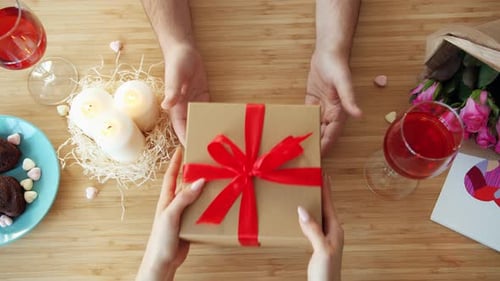 Slow Motion of Man Giving Present in a Gift Box To Woman in Cafe During Dinner