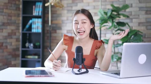 Woman recording podcast from home studio