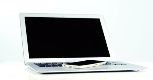 Close-up of laptop and mobile phone