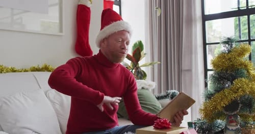 Man with Santa Hat Video Calling on Tablet at Christmas