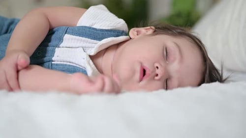 baby are sleeping on the bed at home, cute little boy sleeps sweetly