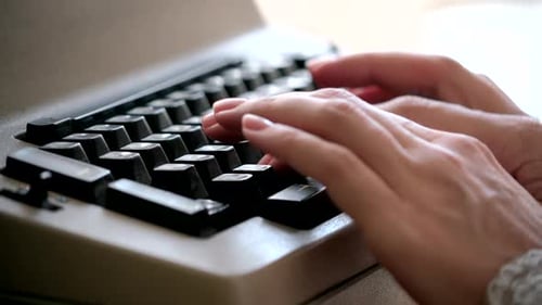 Typewriter. Woman typing on old vintage retro typewriter, fingers press keys