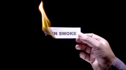 Card with "Up In Smoke" Message Burning