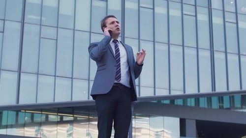 Professional Man on Phone Outside Modern Building