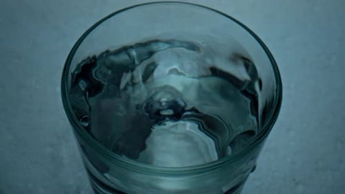 Tablet Dropping Glass Top View Closeup