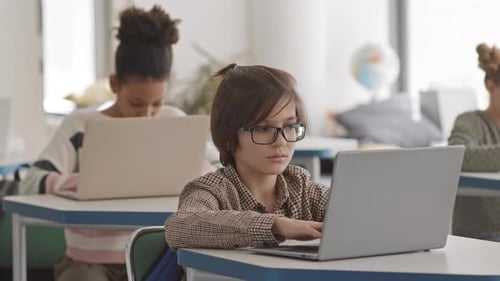 Children Work on Laptops in Classroom