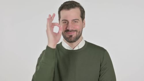 Man Makes OK Gesture on White Background