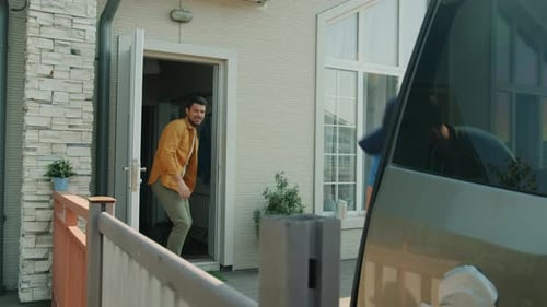 Delivery Driver Hands Box to Man at Home