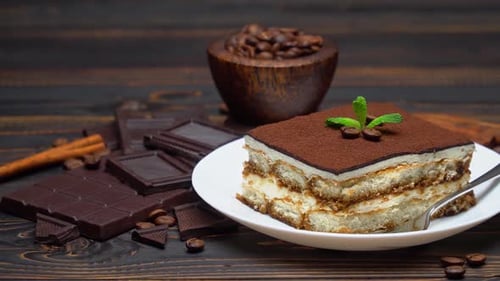 Portion of Traditional Italian Tiramisu Dessert and Pieces of Chocolate Bar