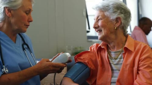 Nurse Checks Senior Woman's Blood Pressure