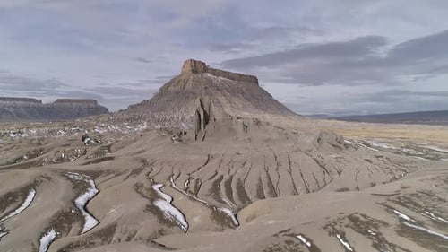 Flying over eroded desert terrain towards Factory Butte