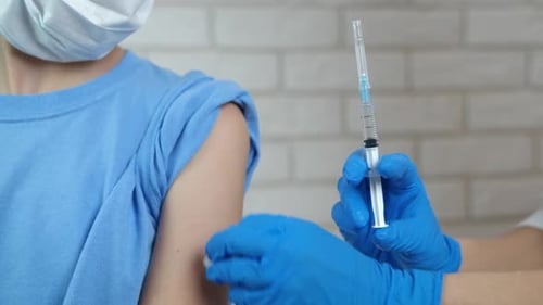 Receiving an Injection in Upper Arm