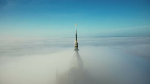 Beautiful Aerial Panning Shot of Glorious Golden Spire at Mont Saint Michel Castle Covered By Epic