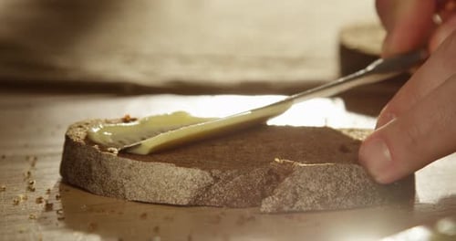 Spreading Butter on Slice of Bread