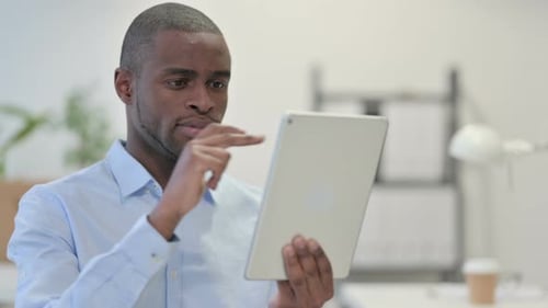 Man Using Tablet in Modern Office