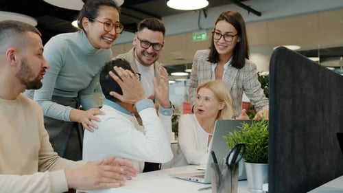 Multi-ethnic Team Talking Clapping Hands Doing High-five in Open Space Office
