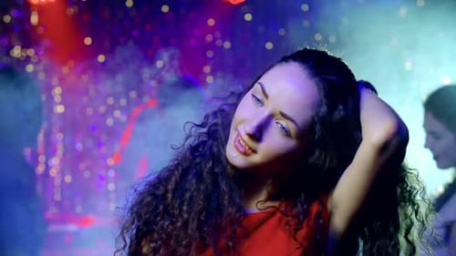 Woman Dancing at Nightclub Party with Bokeh Lights