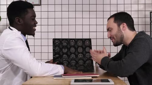 Doctor Explains Brain Scan Results to Patient