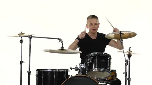 Drummer Plays Vigorous Music on a Drum Set. White Background