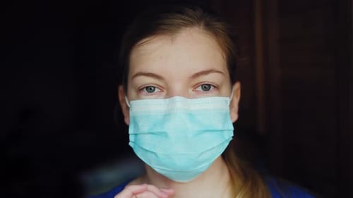 Young Woman Adjusting Medical Mask, Close Up
