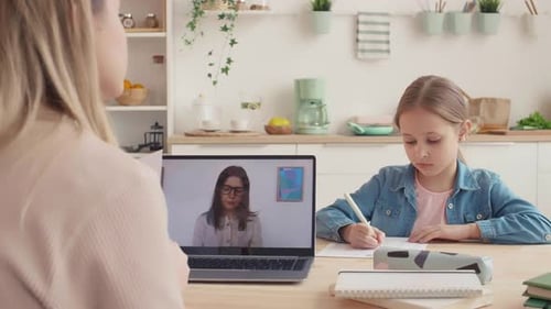 Young Girl Learns Online at Home from Teacher