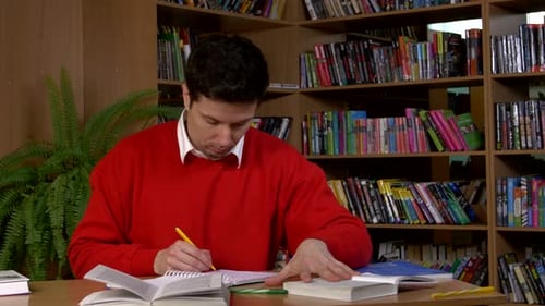 Student Researching with a Book in a Library